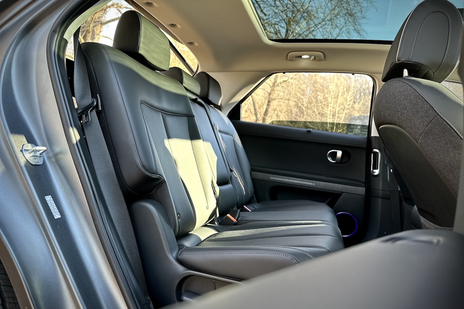 Rear seats in the 2022 Hyundai Ioniq 5 Limited AWD with trees in the back.