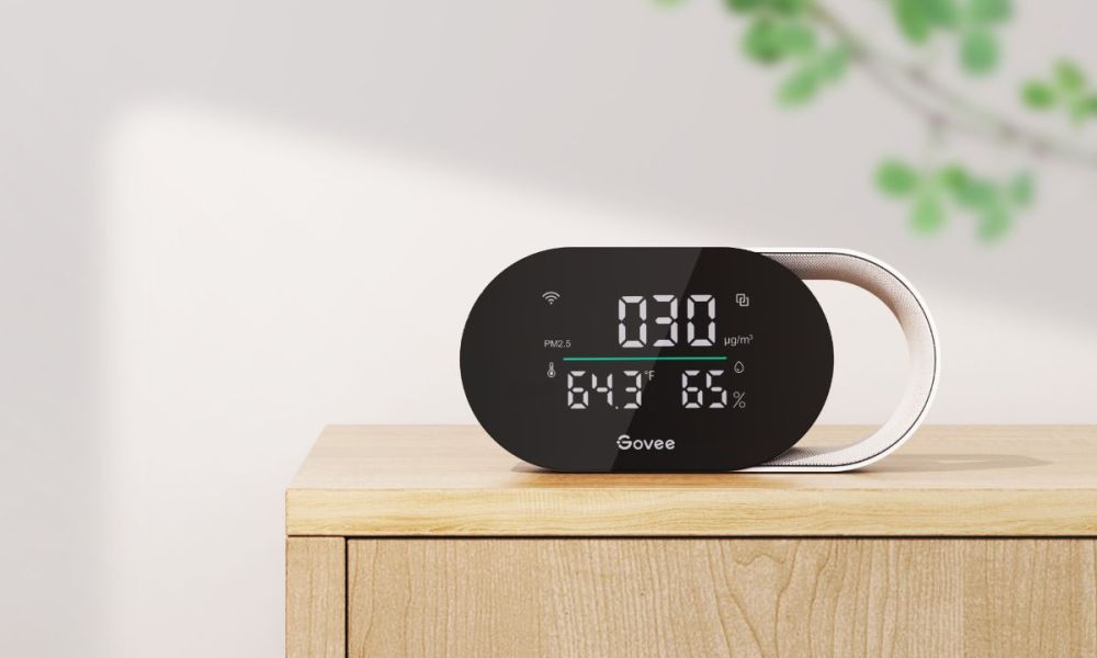 The Govee Smart Air Quality Monitor sitting on a wooden stand.