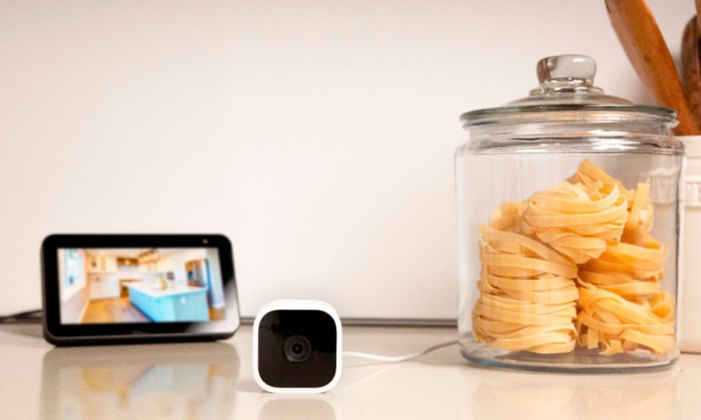 Blink Mini Indoor 1080p wireless security camera on a counter showing video capture on an Echo Show display.