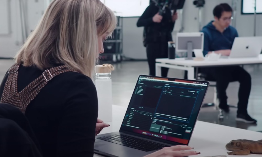 A woman using a MacBook Pro in a studio.