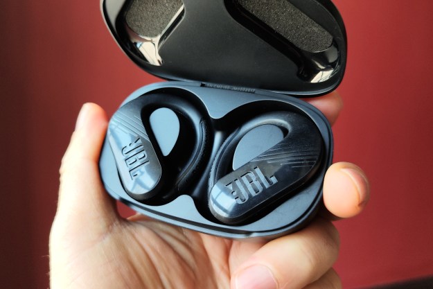 JBL Endurance Peak III in their charging case, hand-held.