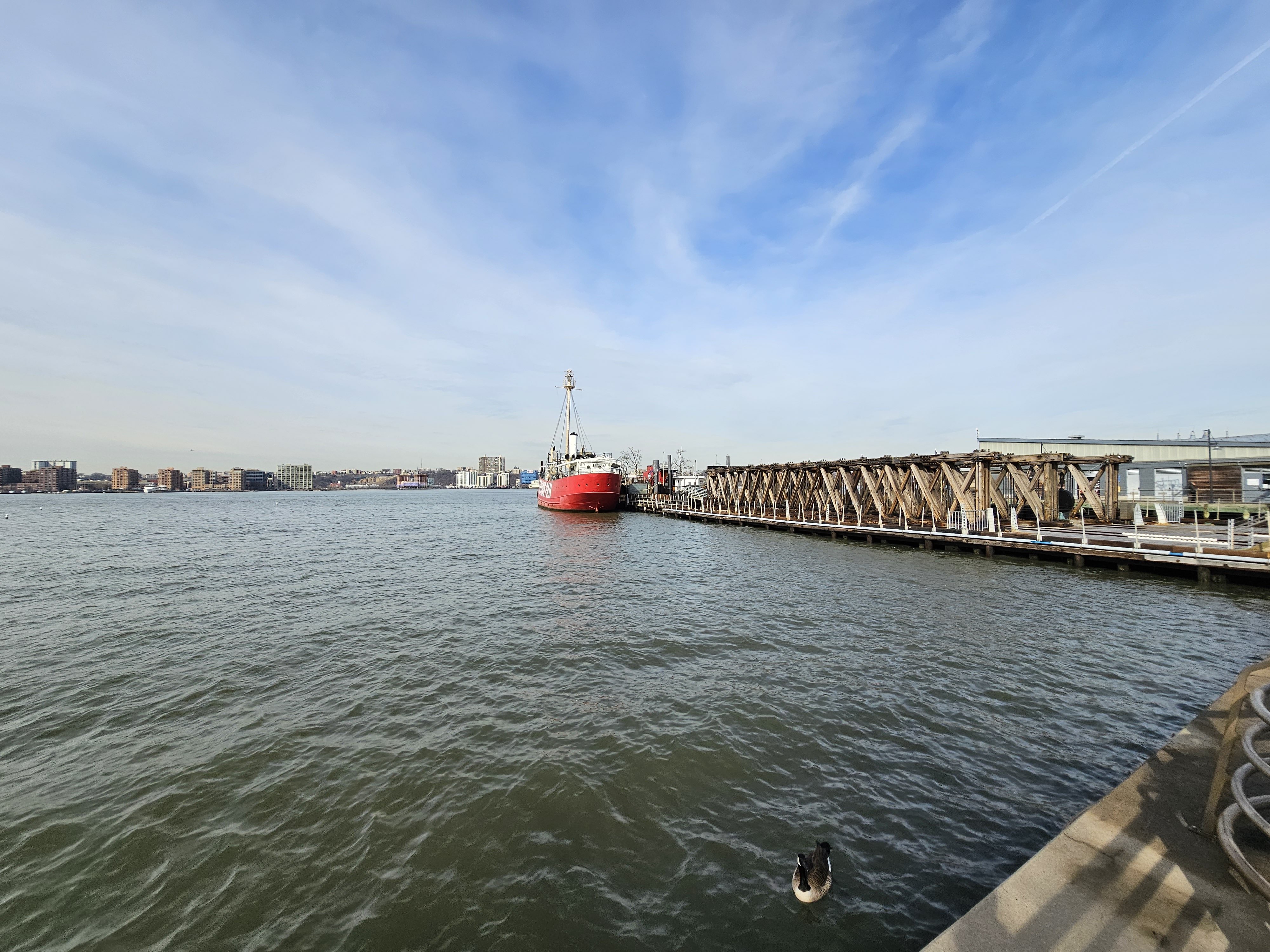 Wide-angle photo from the Galaxy S23 Ultra, showing a red boat by a dock on the water.