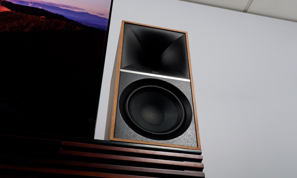 A low-angle view of Klipsch The Nines right-channel speaker next to a TV.