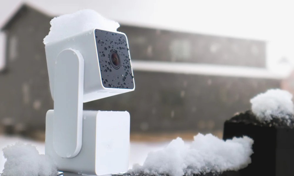 A Wyze camera placed outside in the snow.