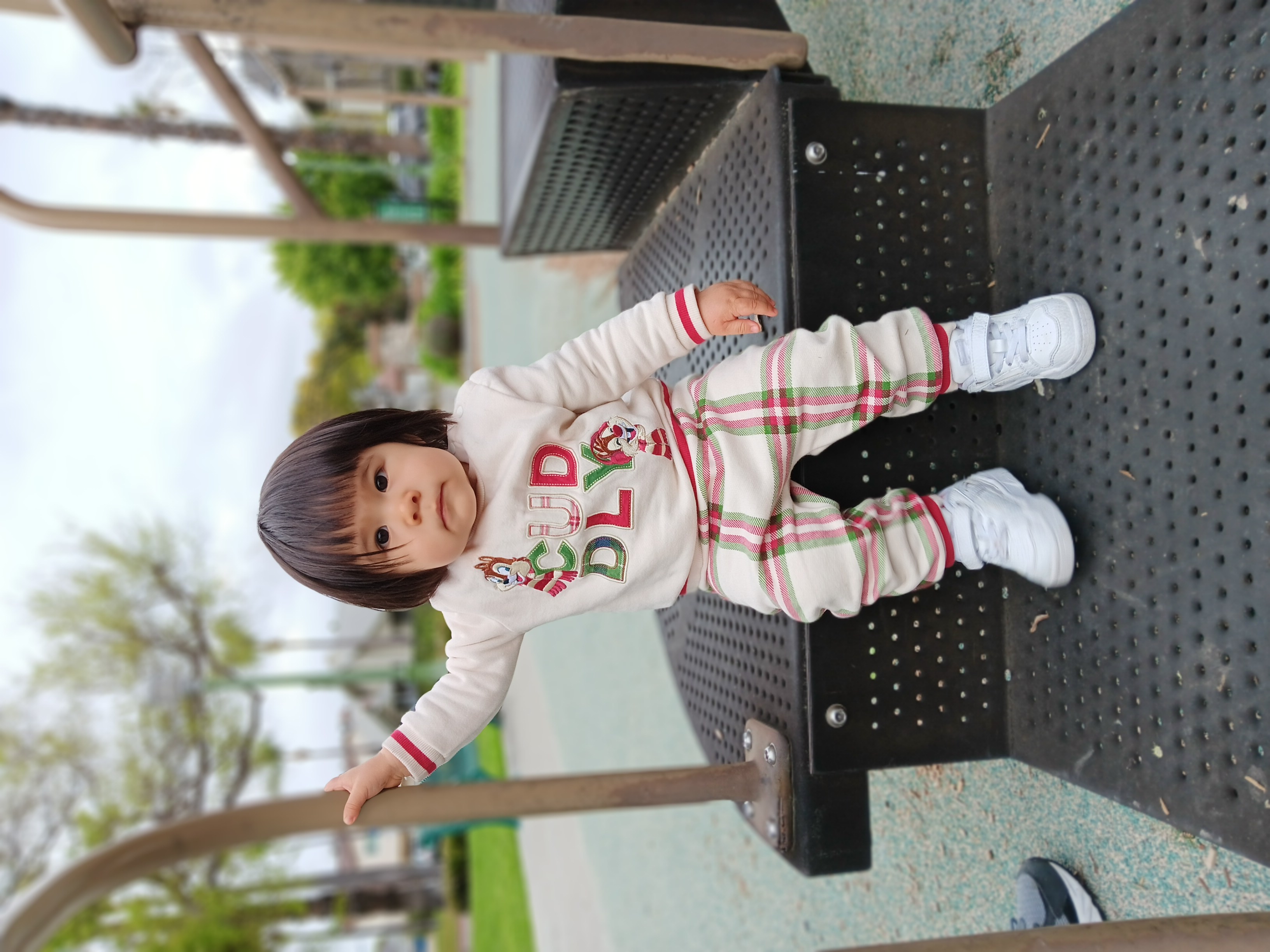 Toddler sitting on playground steps taken with Samsung Galaxy A14 5G portrait mode