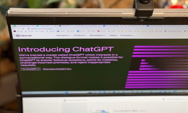 OpenAI's ChatGPT blog post is open on a computer monitor, taken from a high angle.