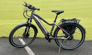 An Aventon Level 2 ebike sits outside a grocery store.