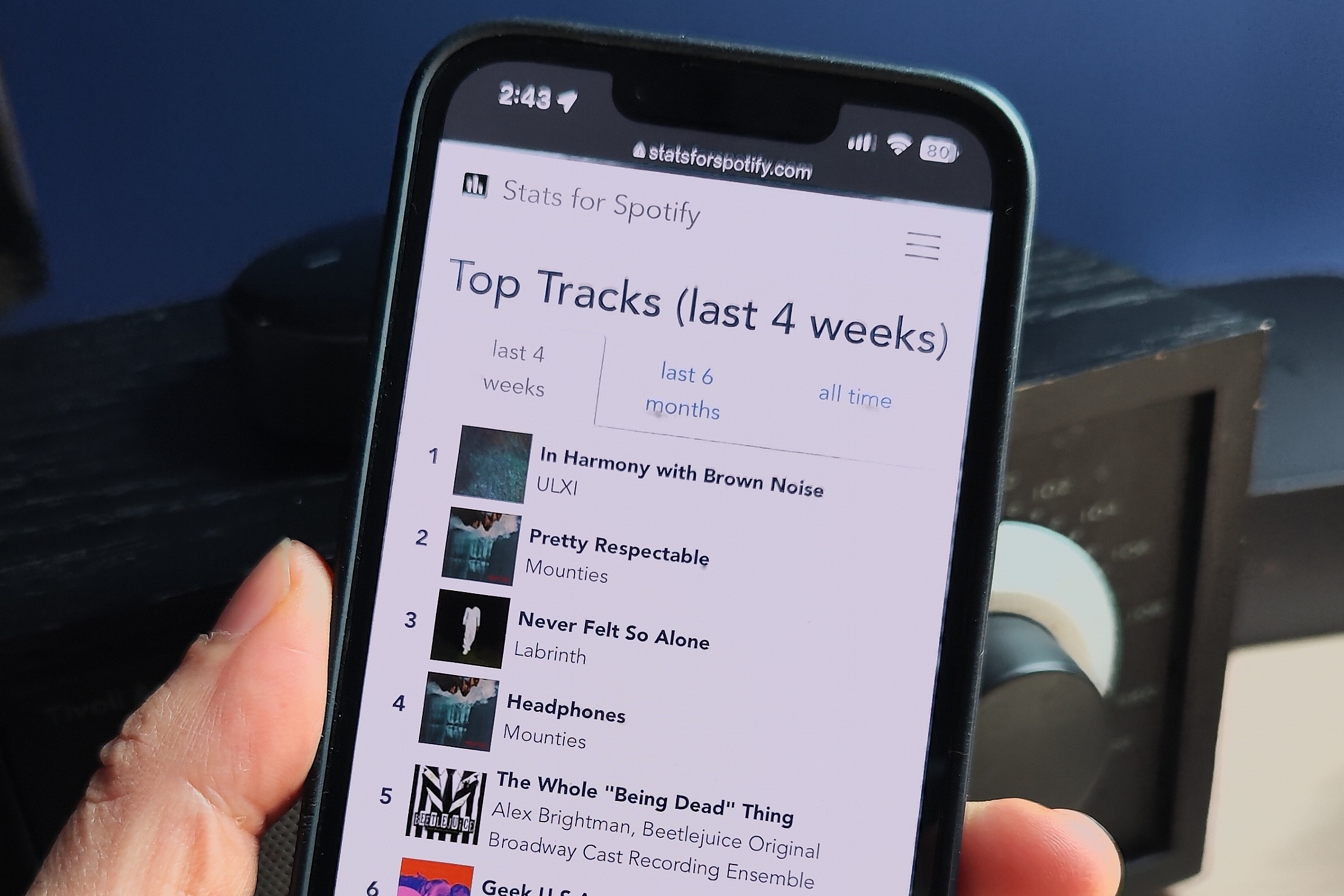 how to use stats for spotify top tracks phone in hand close