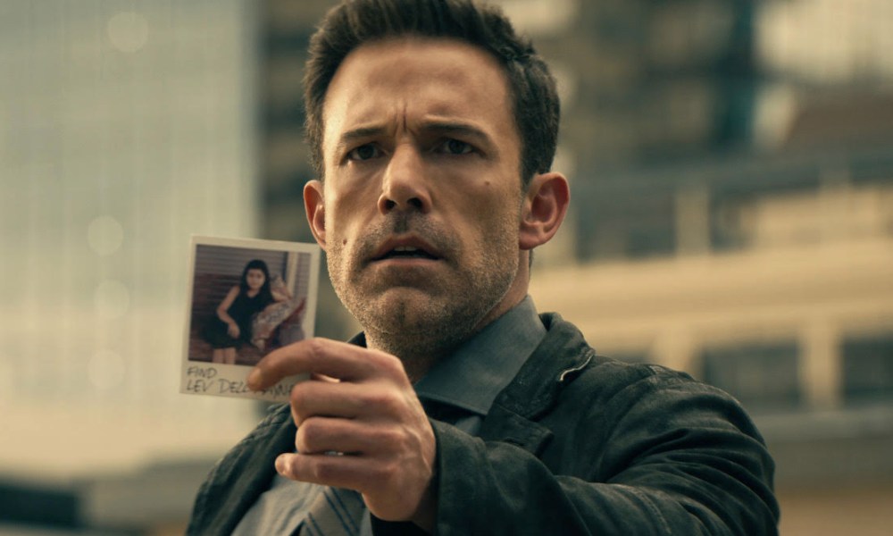 Ben Affleck holds up a photograph in Hypnotic.