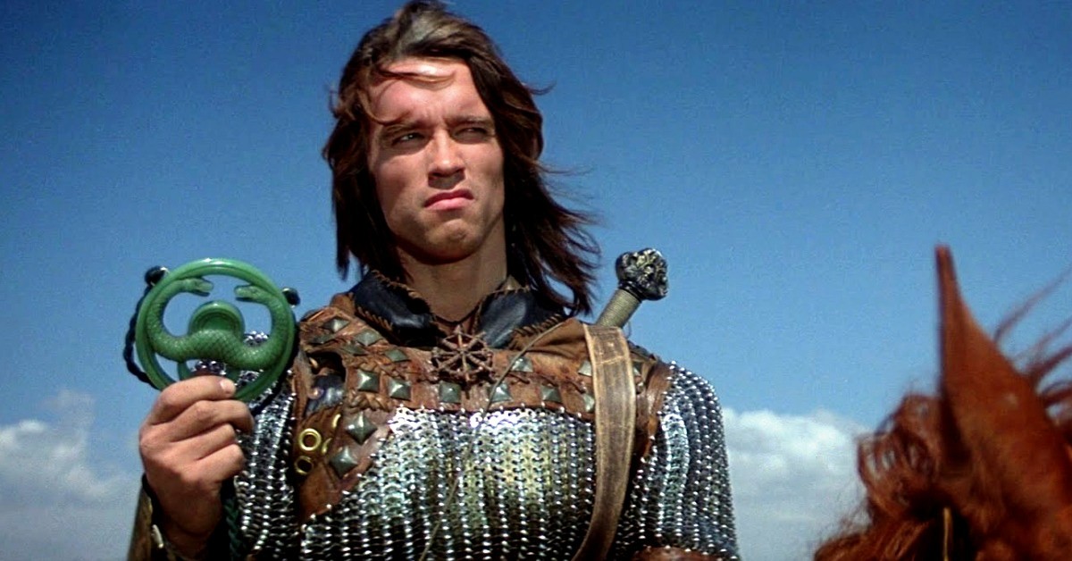 Conan holds a metal symbol in 1982's Conan The Barbarian.