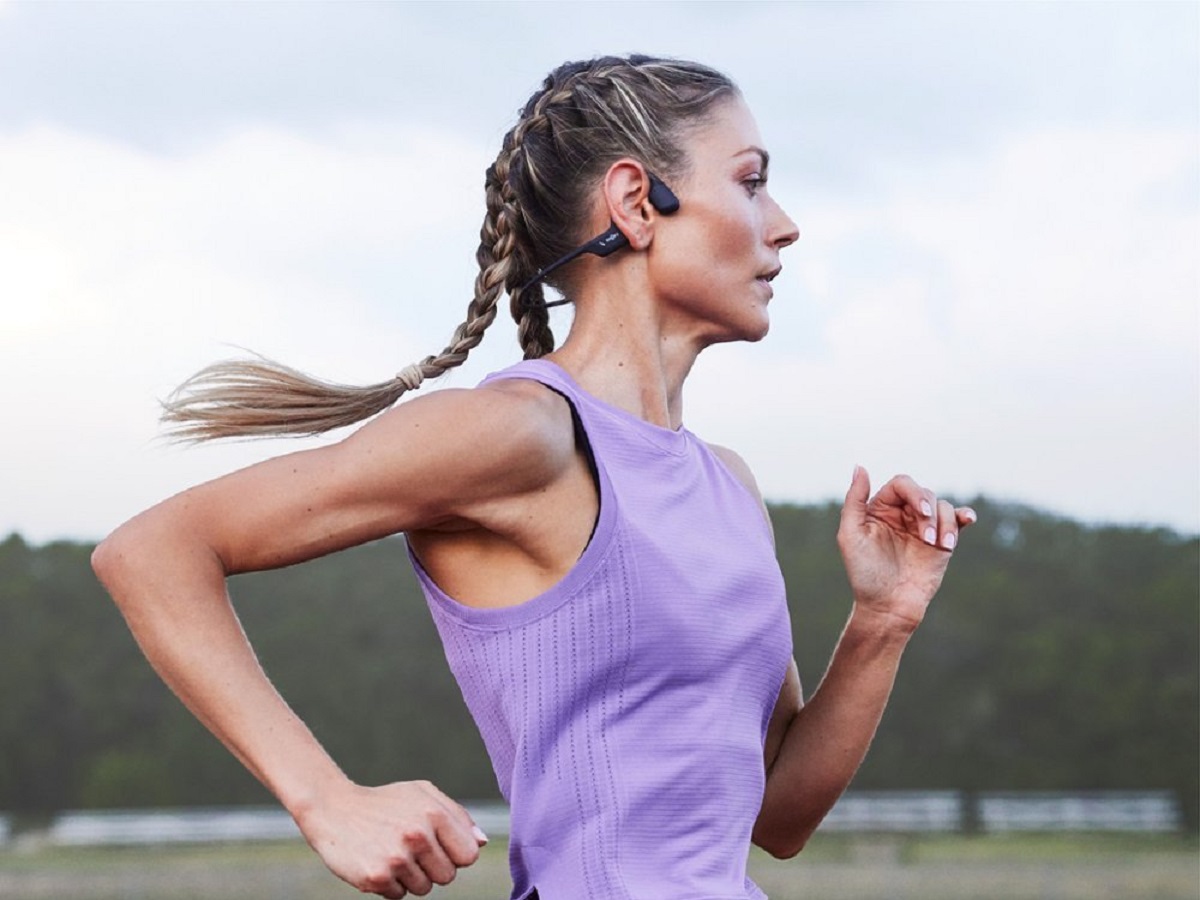 A runner wearing the Shokz OpenRun Pro bone conduction headphones.