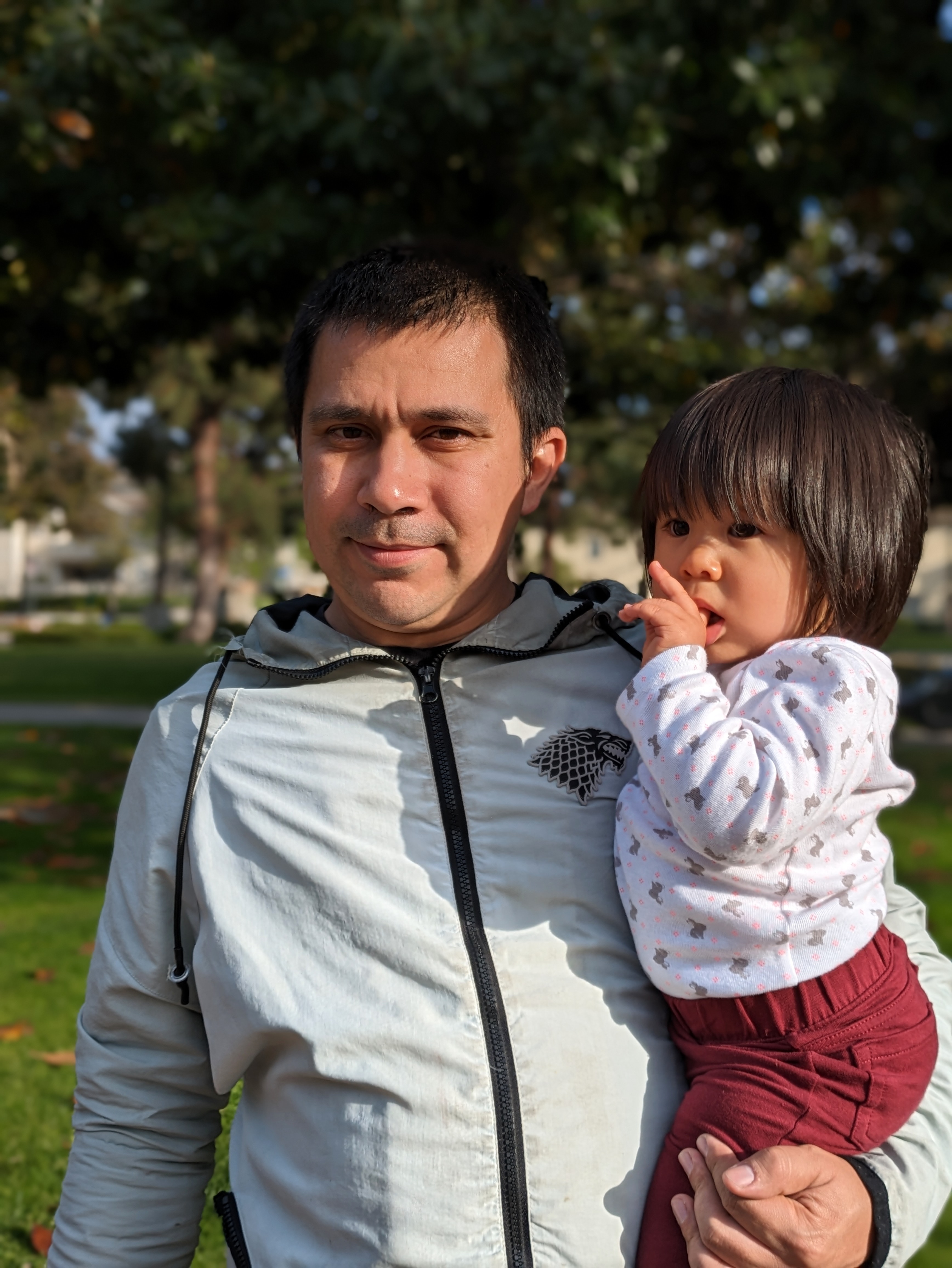 Portrait mode photo of dad and toddler daughter taken with Google Pixel 7a