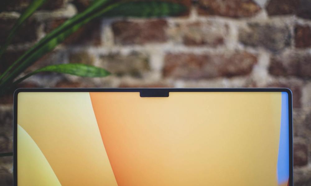 An Apple MacBook laptop with the macOS Ventura background wallpaper and the notch seen at the top of the display.