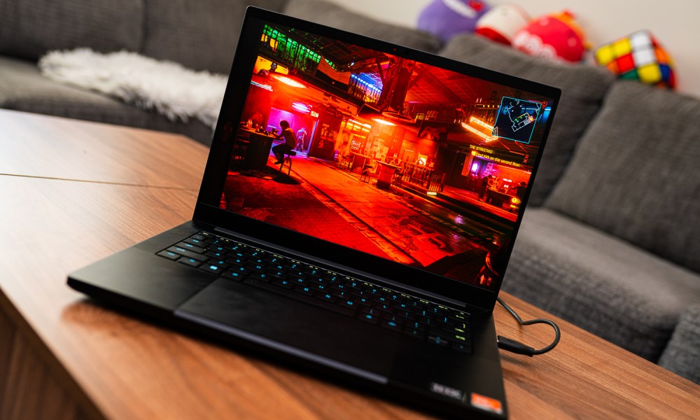 A Razer Blade 14 gaming laptop on a coffee table.