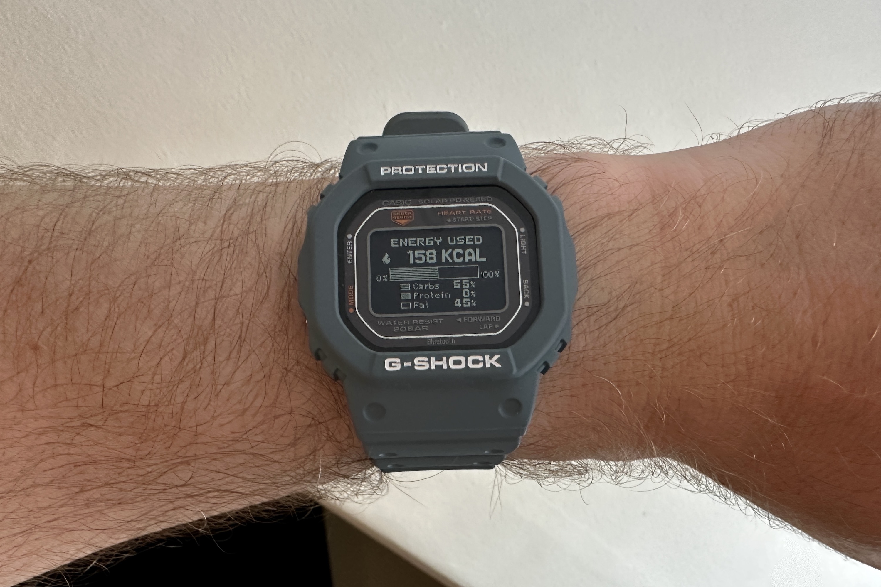 A person wearing the Casio G-Shock DW-H5600, showing workout energy data.