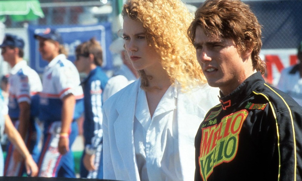 Nicole Kidman and Tom Cruise stand beside one another in Days of Thunder.