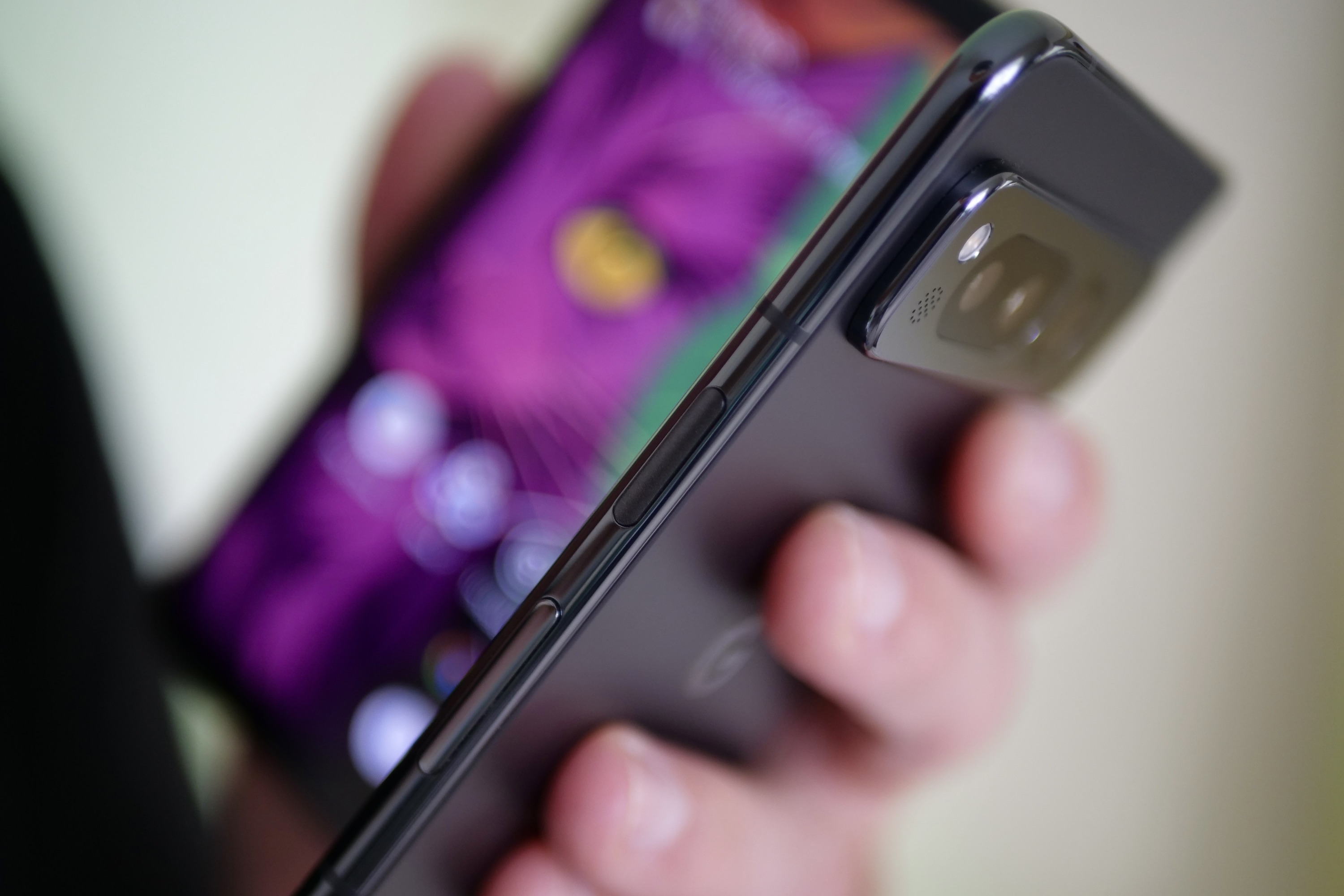 A person holding the Google Pixel Fold showing the buttons.