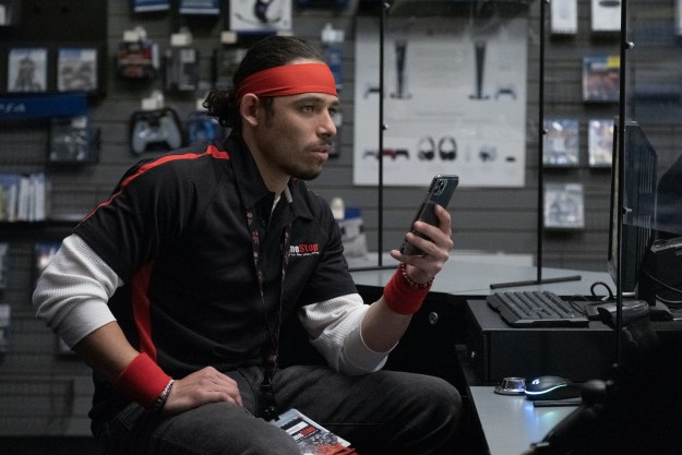 Anthony Ramos wears a GameStop uniform in Dumb Money.