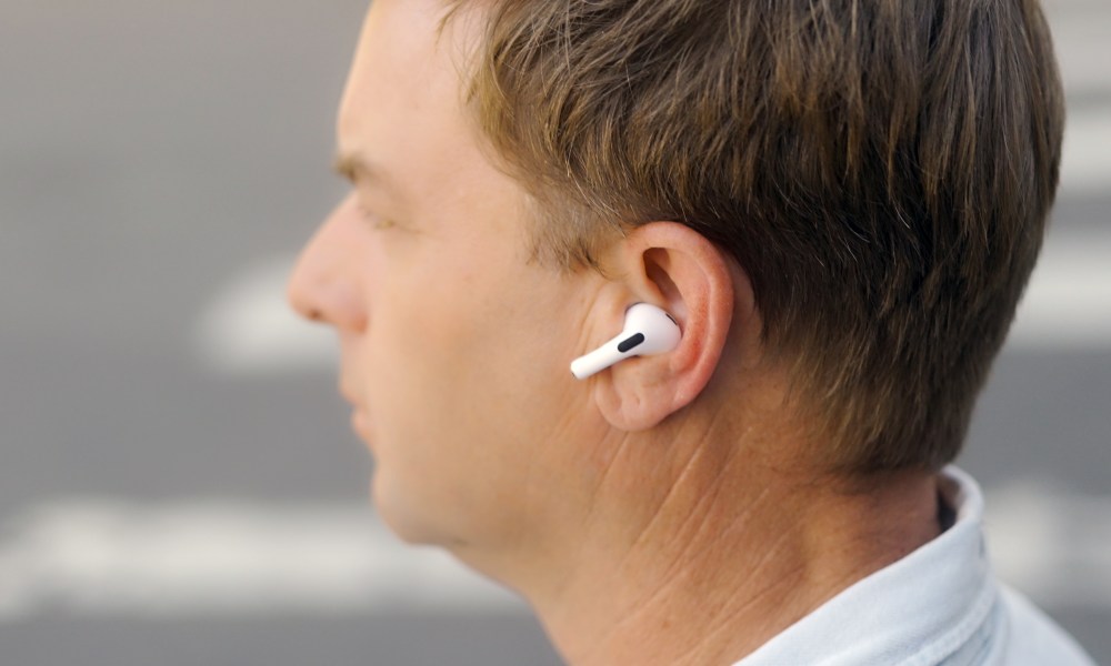 A person wearing the Apple AirPods Pro 2.