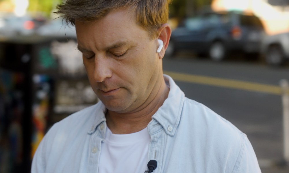 A man wearing the Apple AirPods Pro 2 with USB-C and MagSafe.