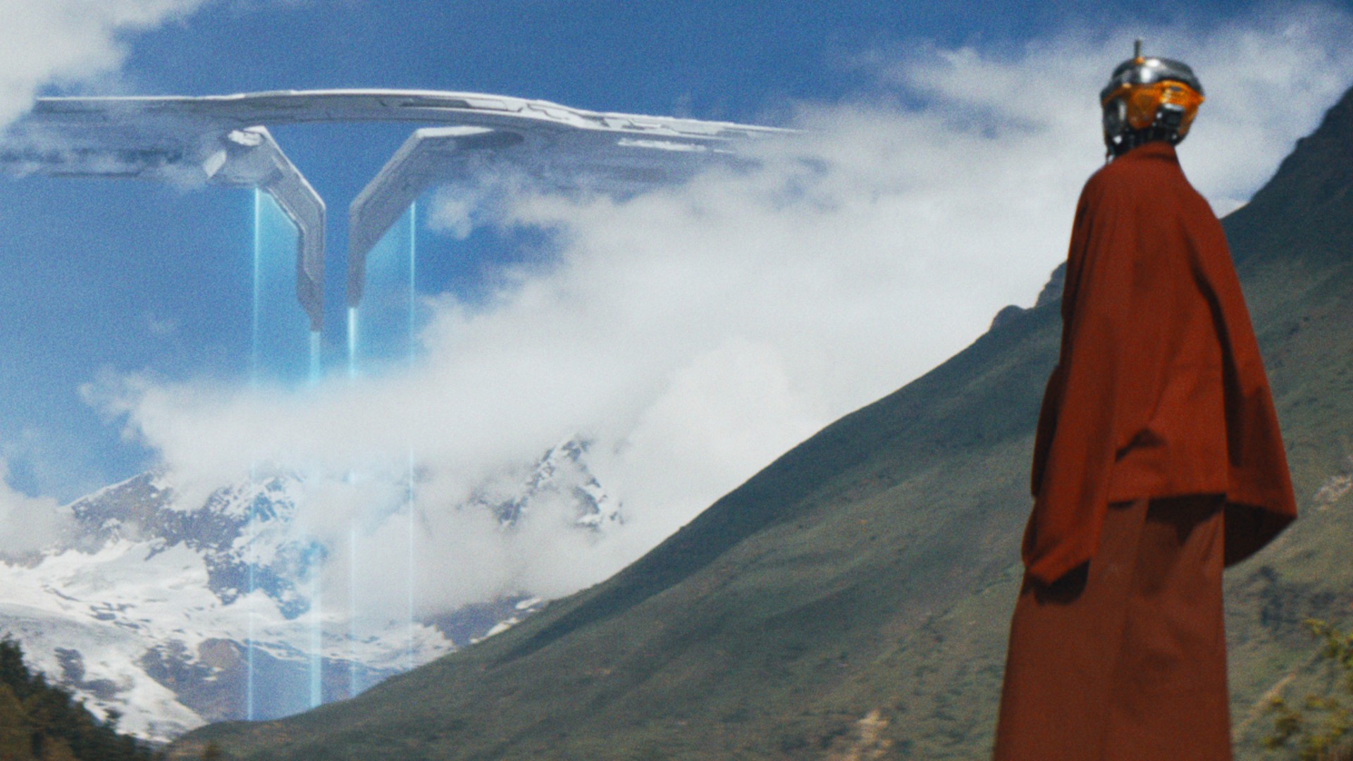 A monk-like android sees a hostile drone shift emerge from the clouds in the distance.