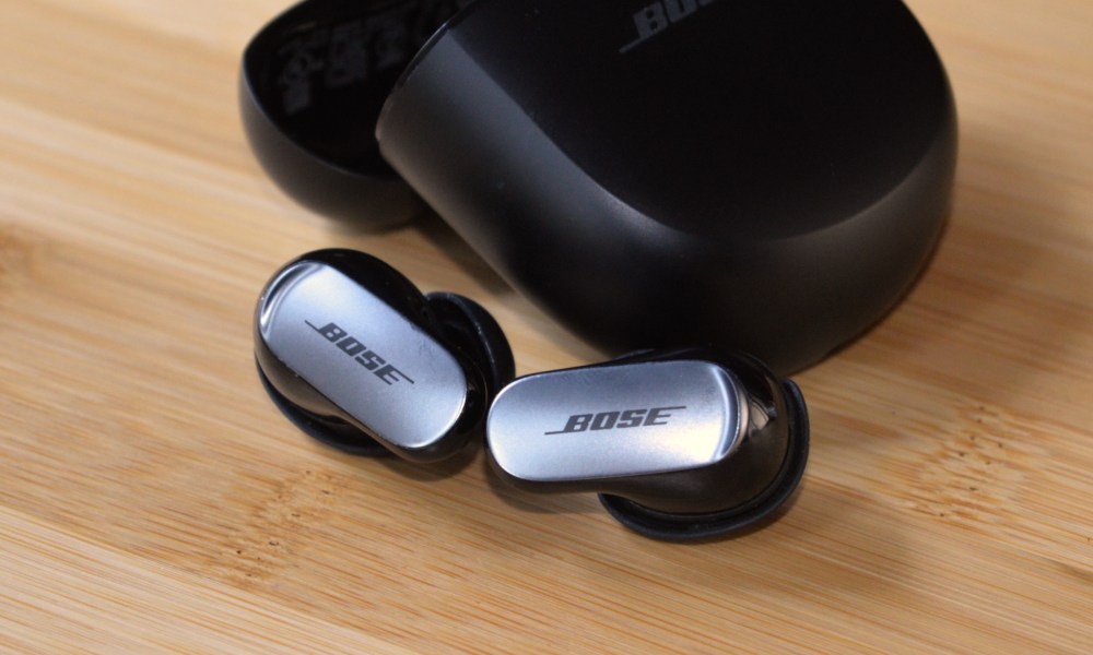 Bose QuietComfort Ultra Earbuds in front of charging case.