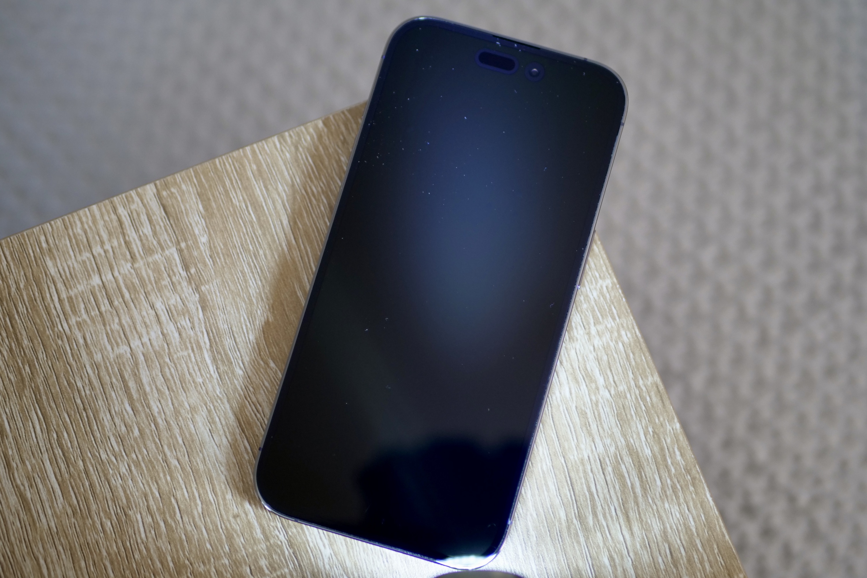 Ceramic Shield on the iPhone 14 Pro, with light to show scratches.