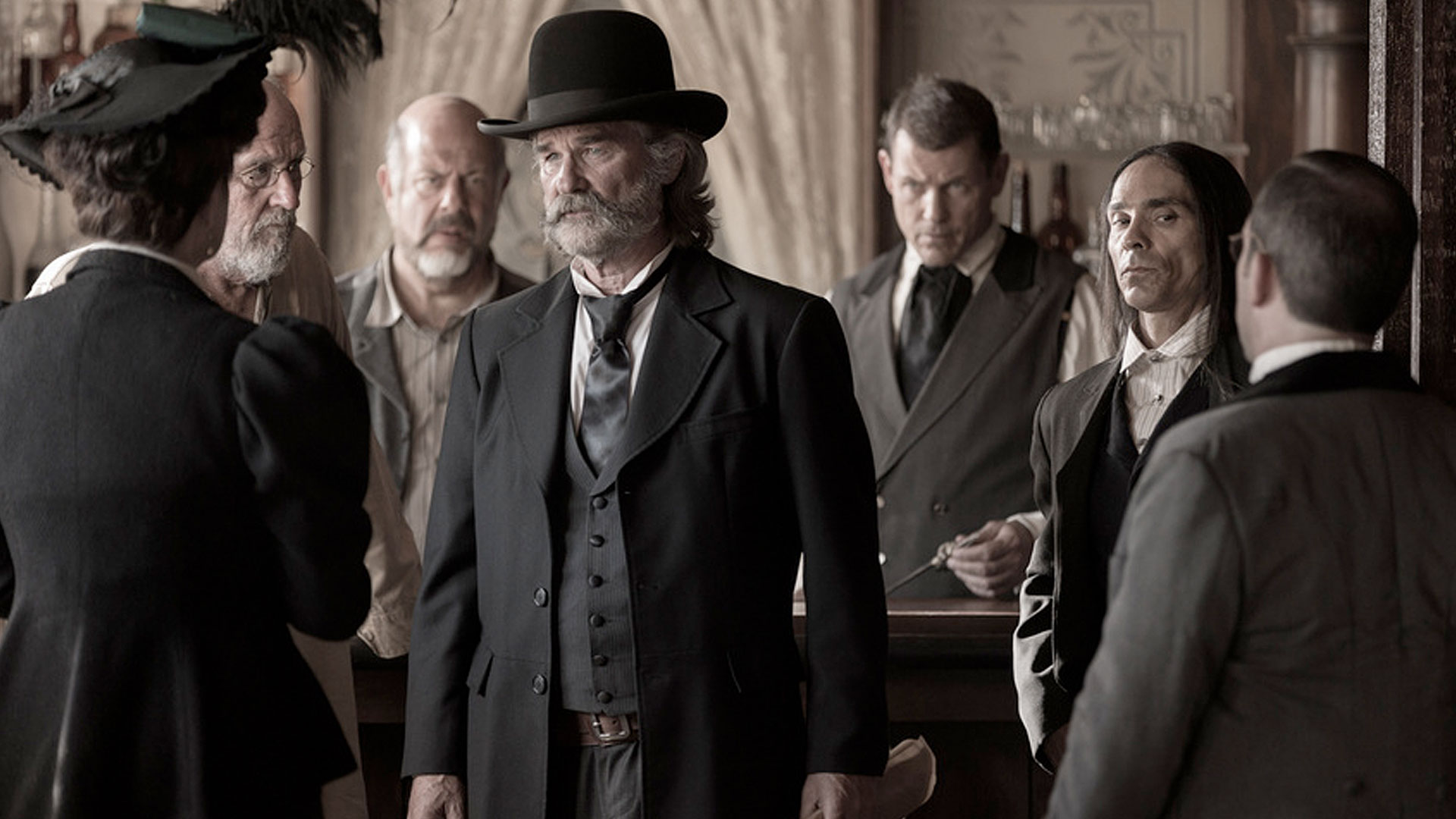 Kurt Russell as Franklin Hunt standing among other men in the film Bone Tomahawk.