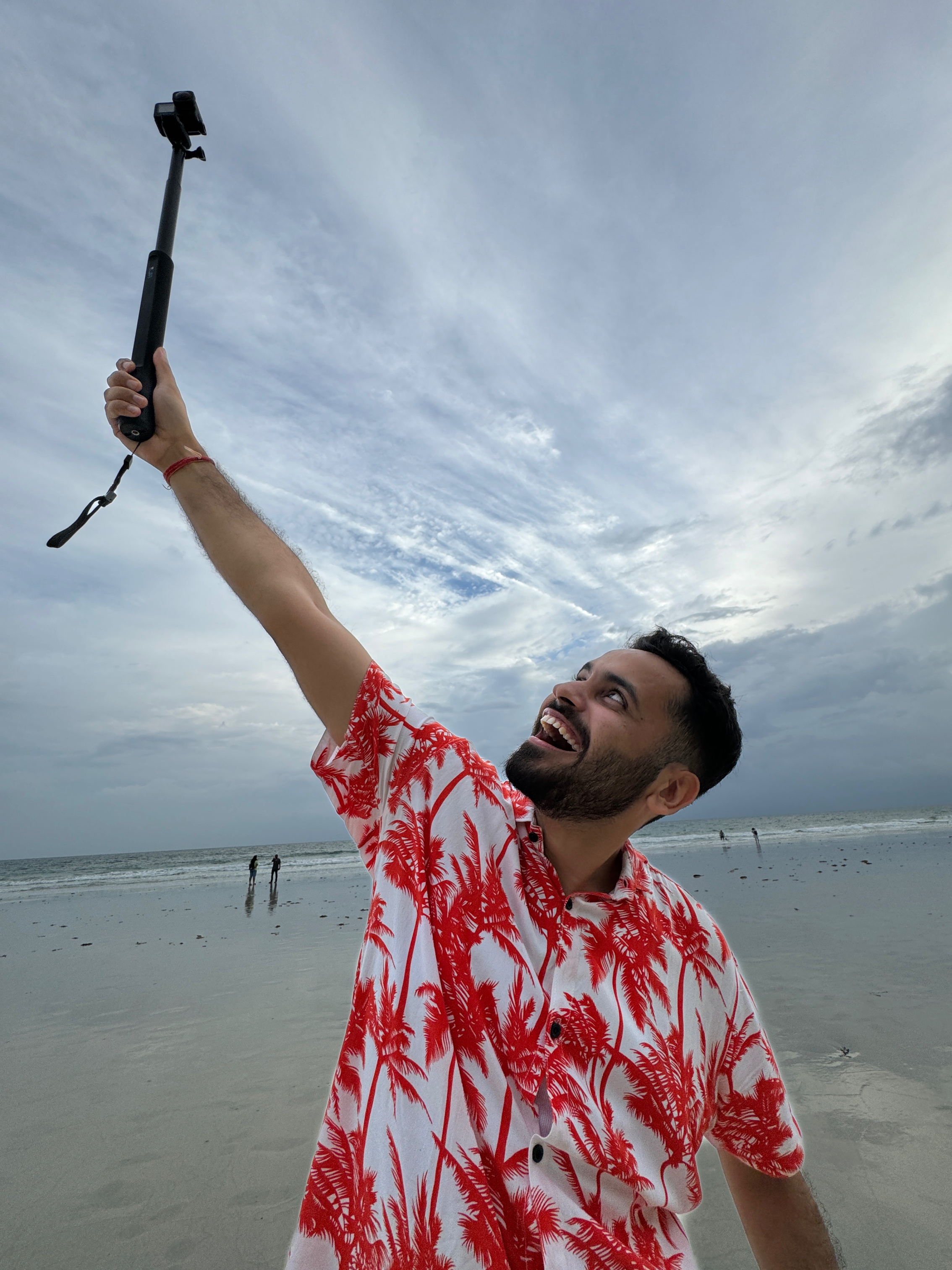 Prakhar Khanna in red printed shirt clicked on iPhone 15 Pro.