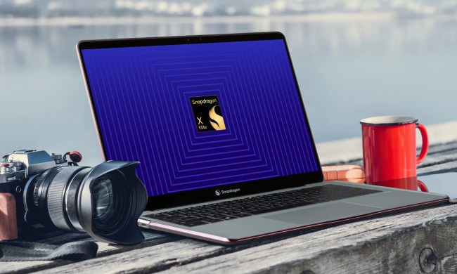 A laptop and a camera on a table with a Qualcomm logo on the screen.