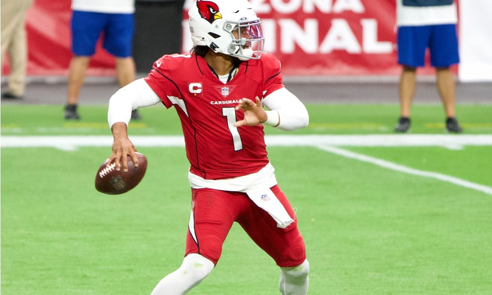 Kyler Murray prepares to throw a football.