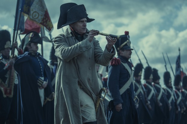 Joaquin Phoenix holds a spyglass in Napoleon.