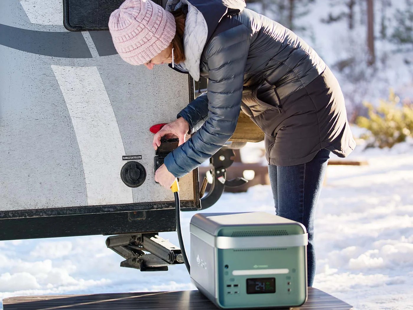 Woman plugging Yoshino BT4000 SST power station into RV