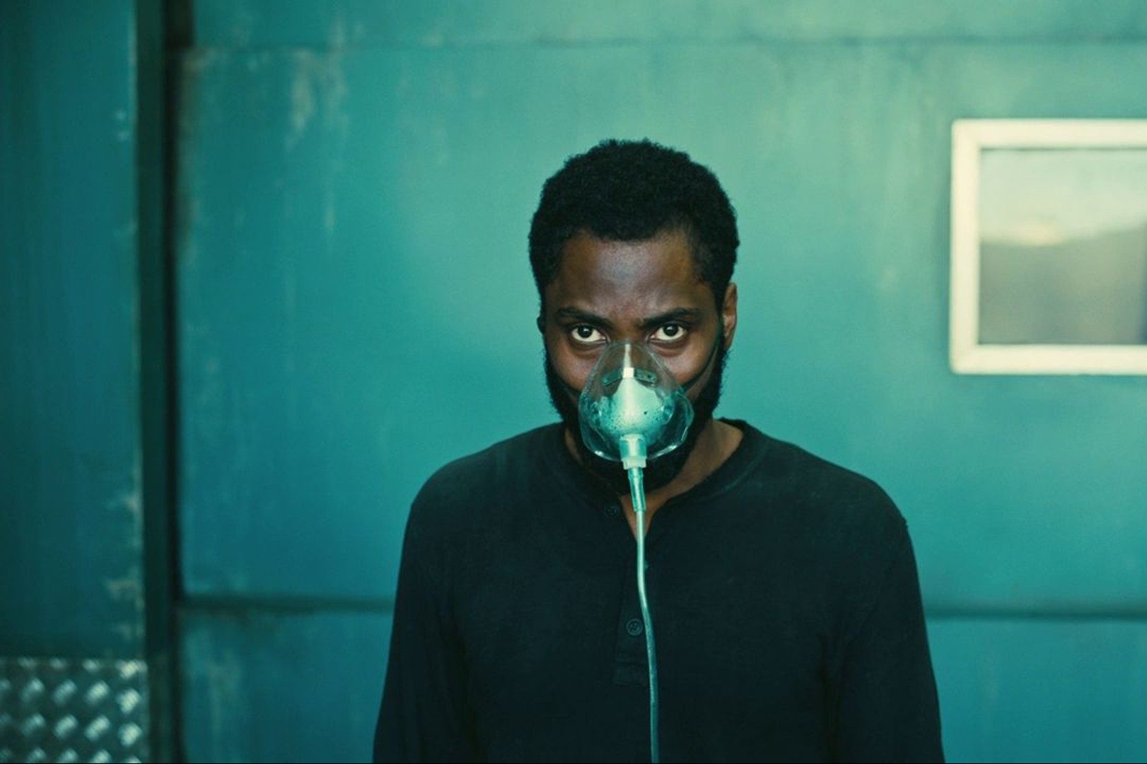 John David Washington wears a mask in a still from Tenet