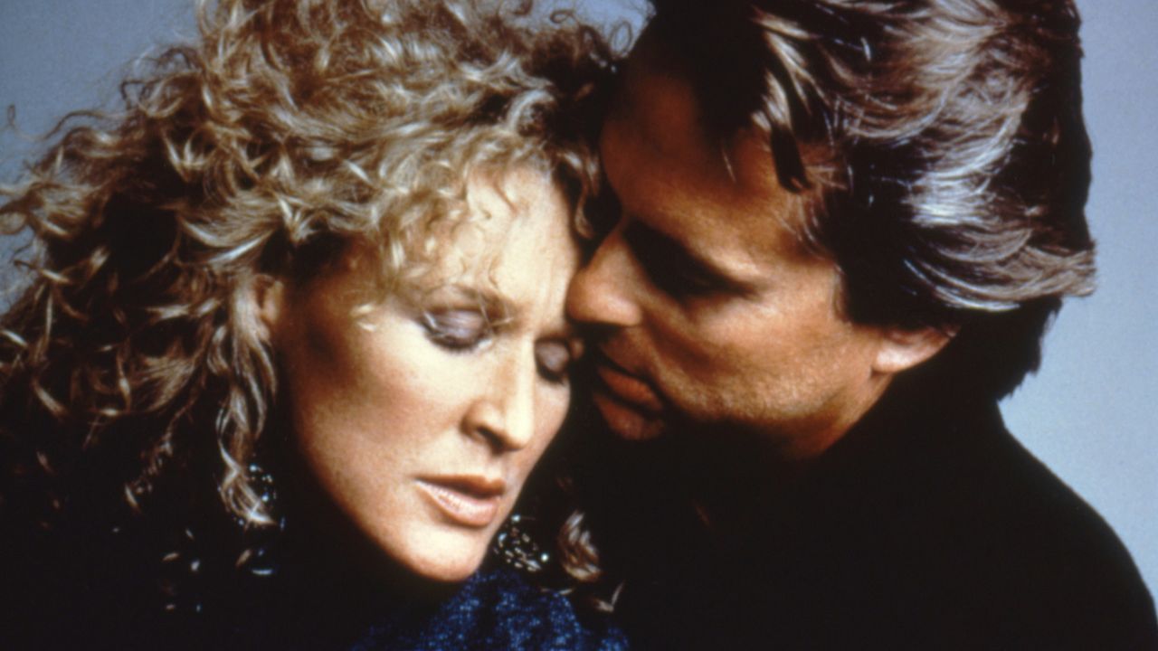 A promo image for Fatal Attraction featuring Glenn Close and Michael Douglas embracing.