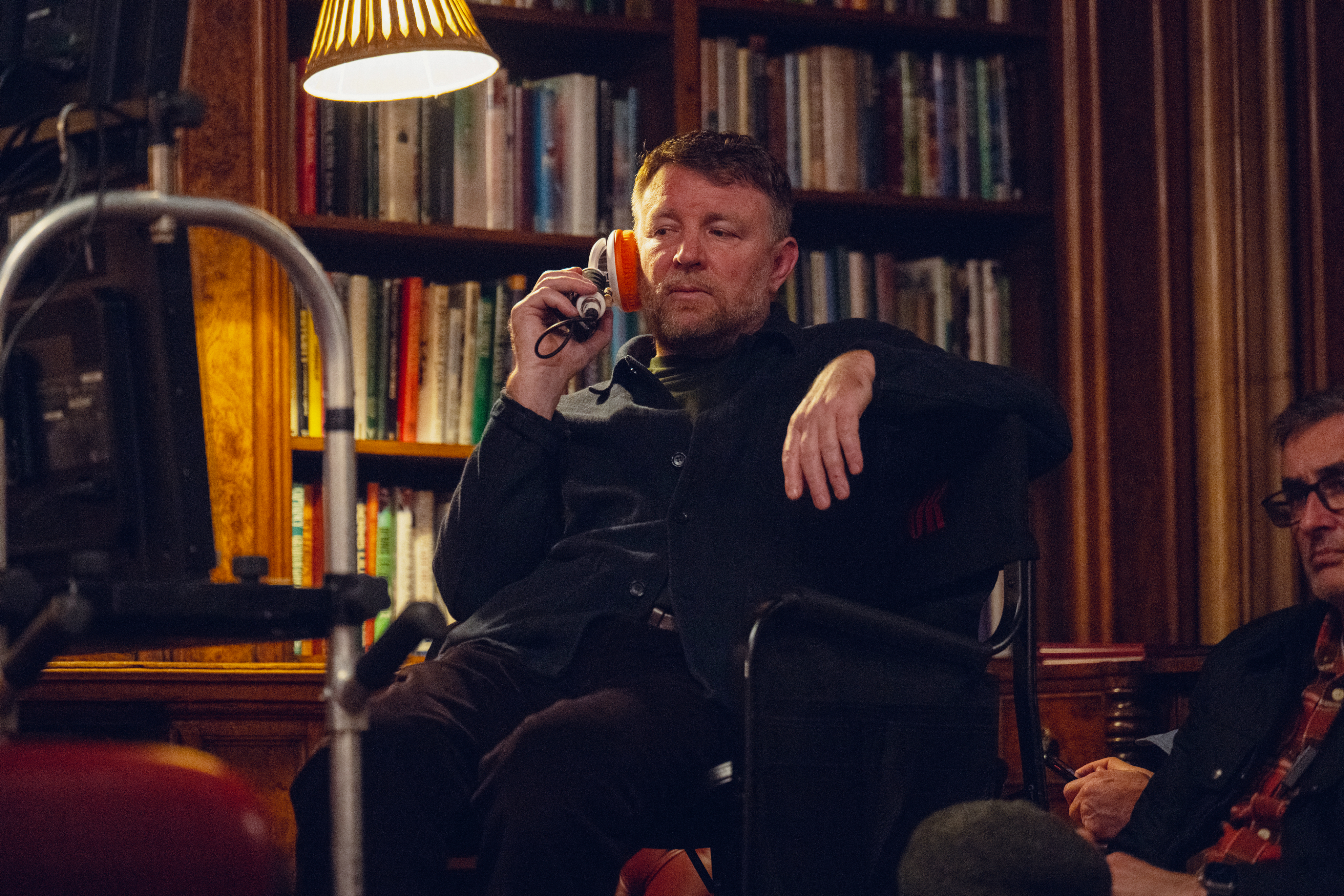 Guy Ritchie looks at a monitor on set of The Gentlemen.