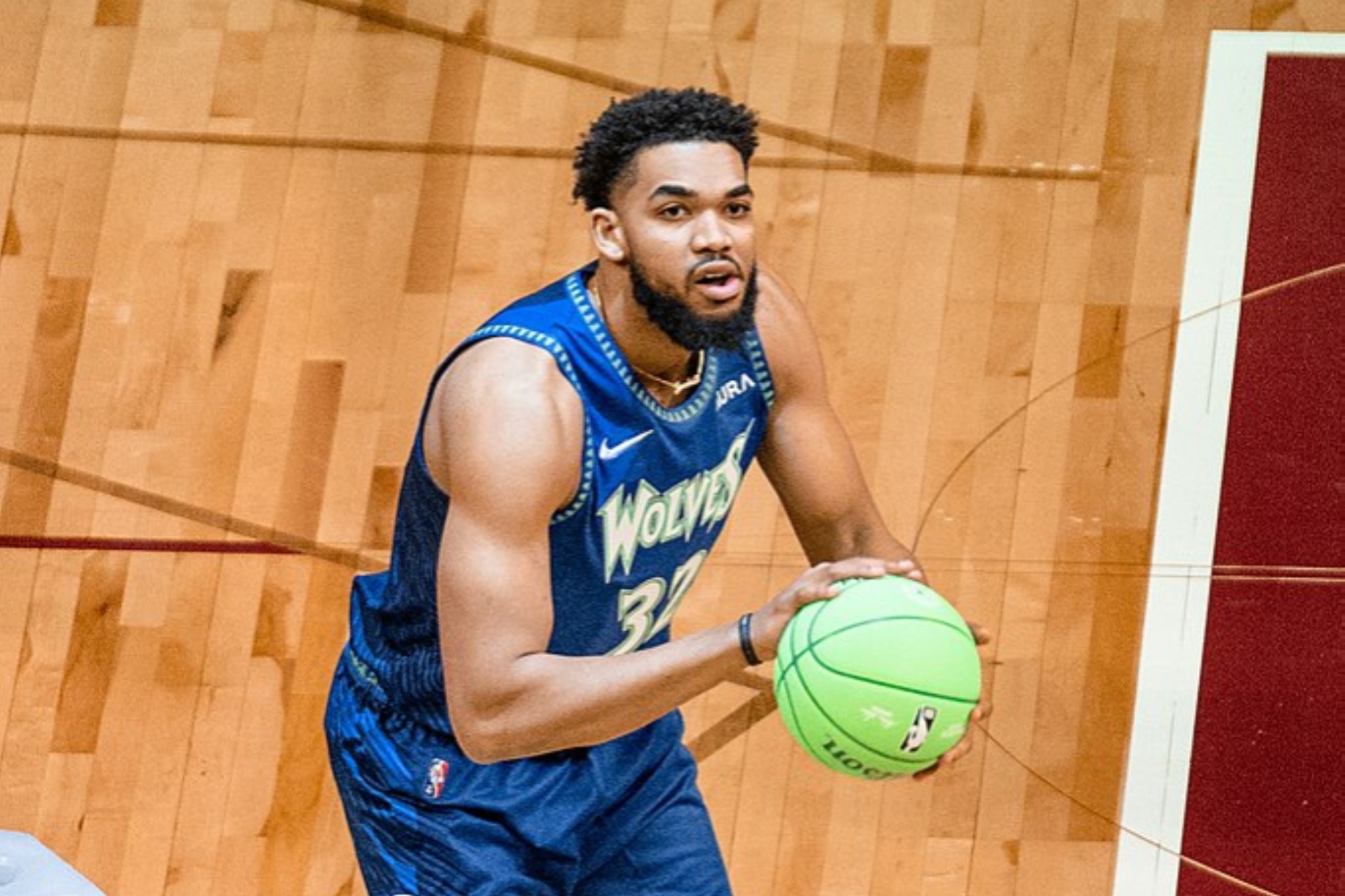 Karl-Anthony Towns holds a basketball and readies for a shot.