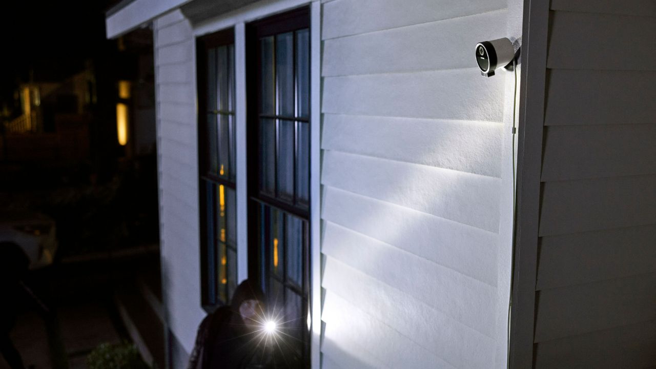 A SimpliSafe outdoor camera monitoring a stranger.