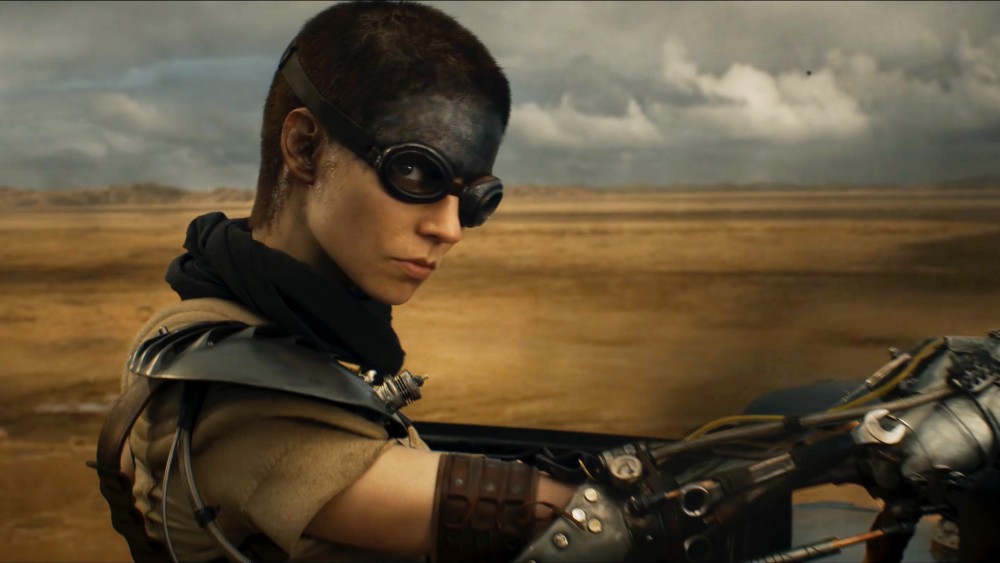 A woman rides her bike in Furiosa.