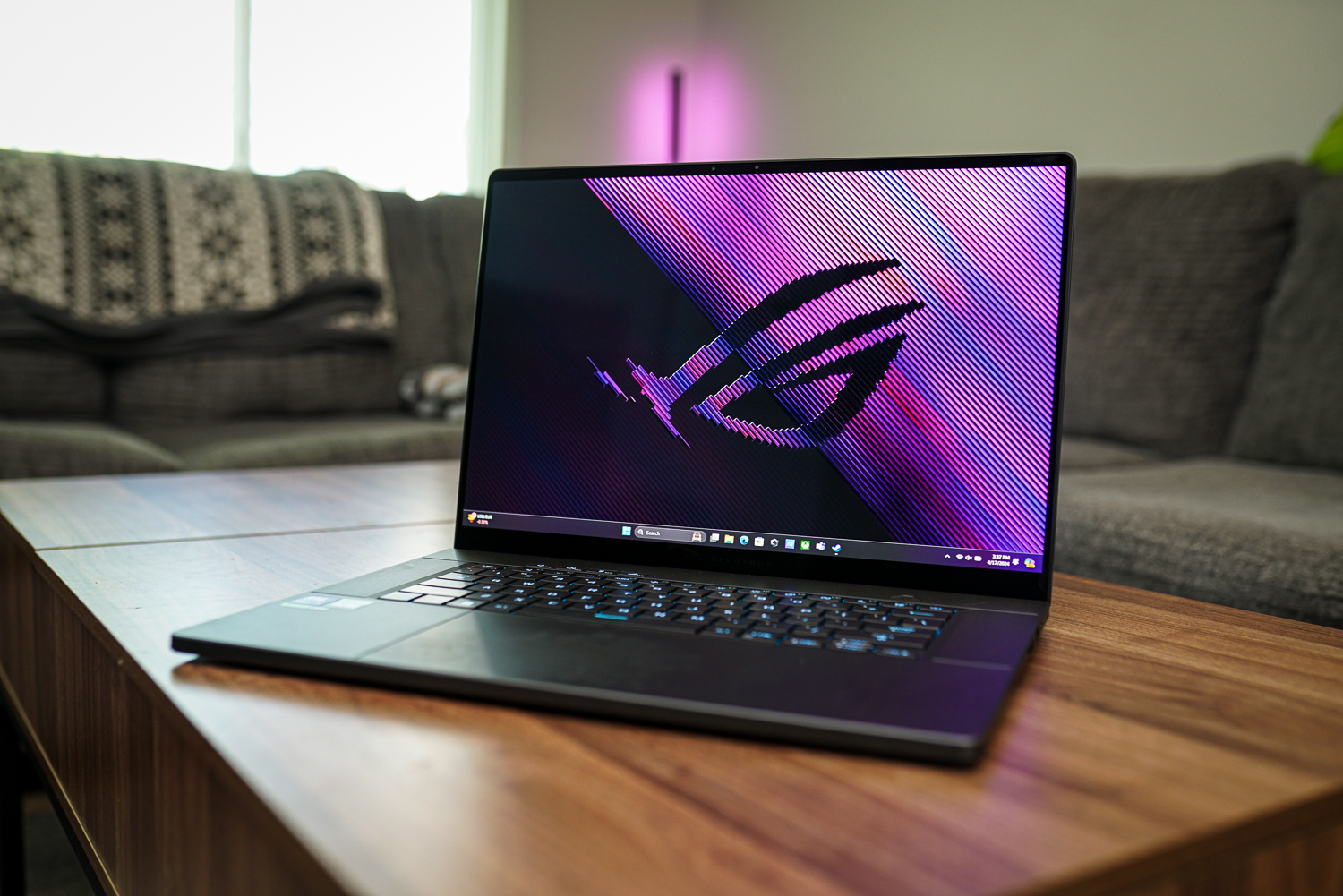 The Asus ROG Zephyrus G16 sitting on a coffee table.