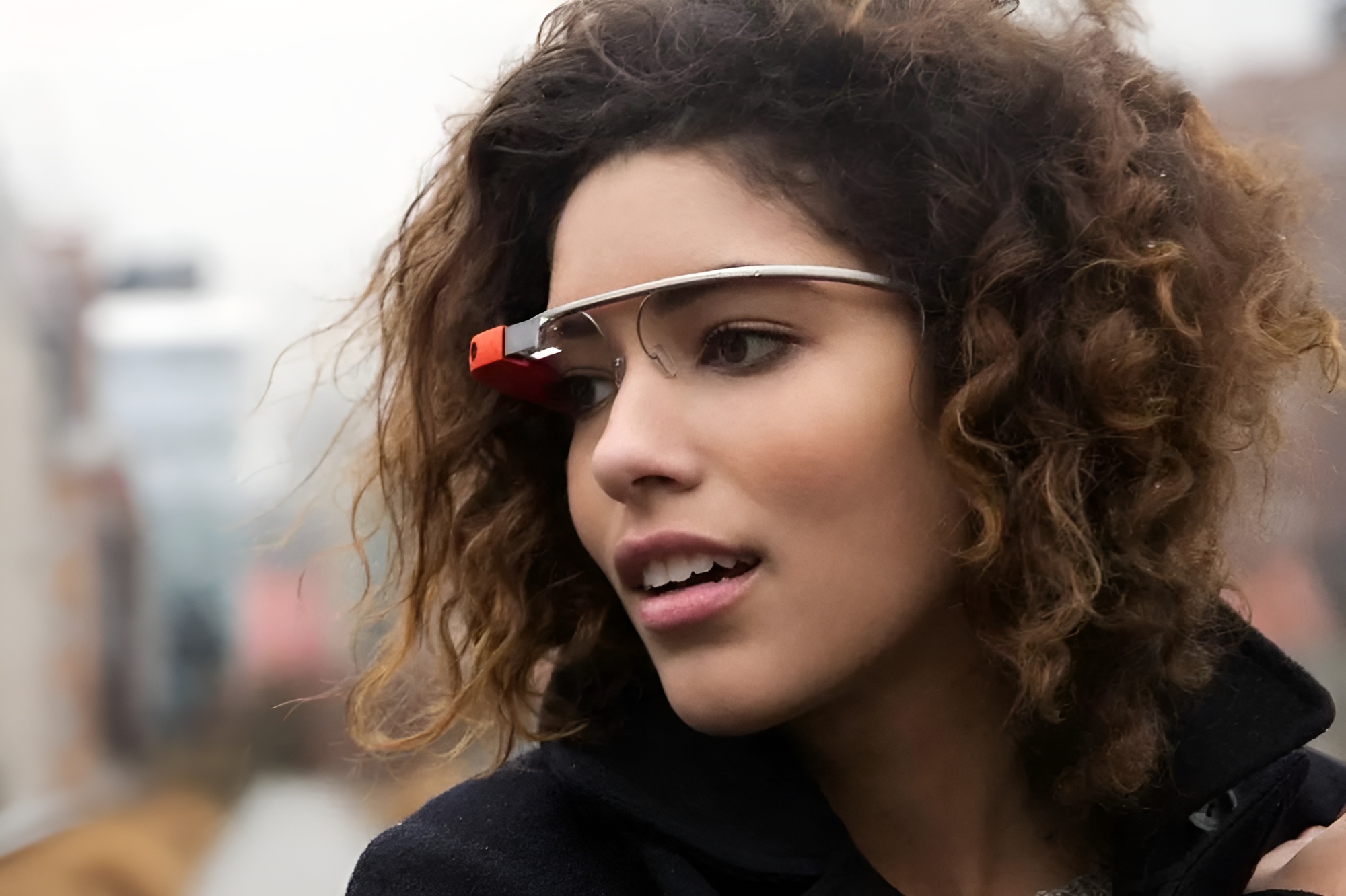 A closeup shot shows a person wearing Google Glass.