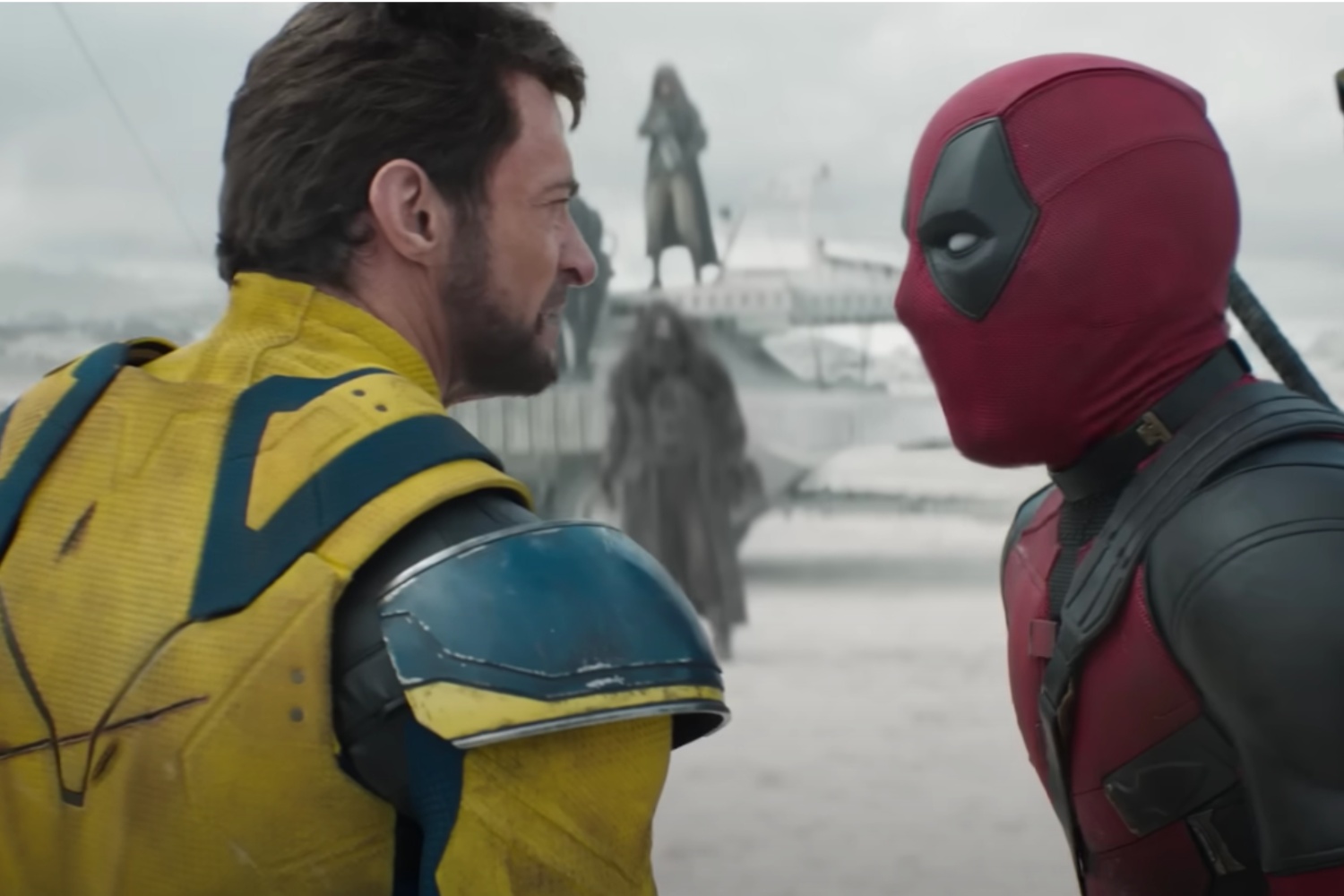 Wolverine stands nexts to Deadpool and argues.