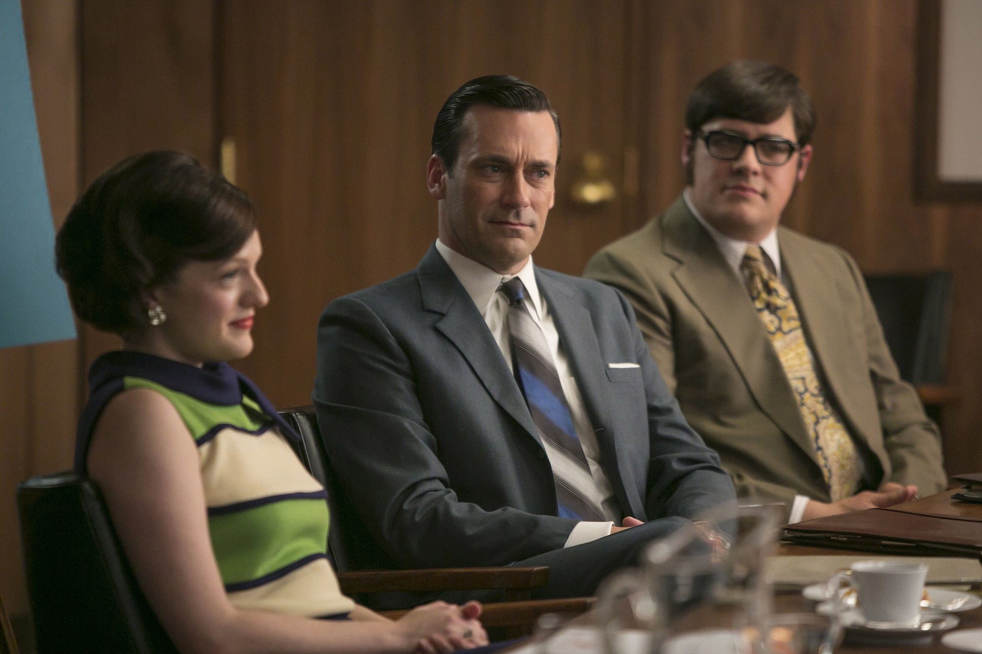 Don sits with Peggy and Harry in Mad Men.