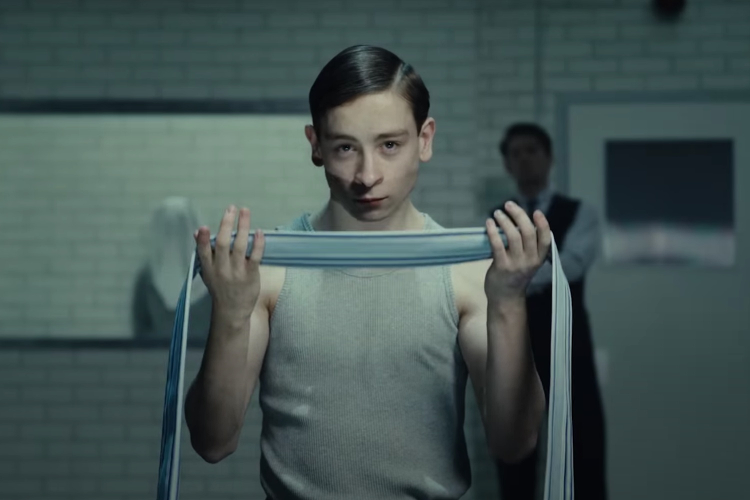 A boy holds a blindfold and readies to put it around his eyes.