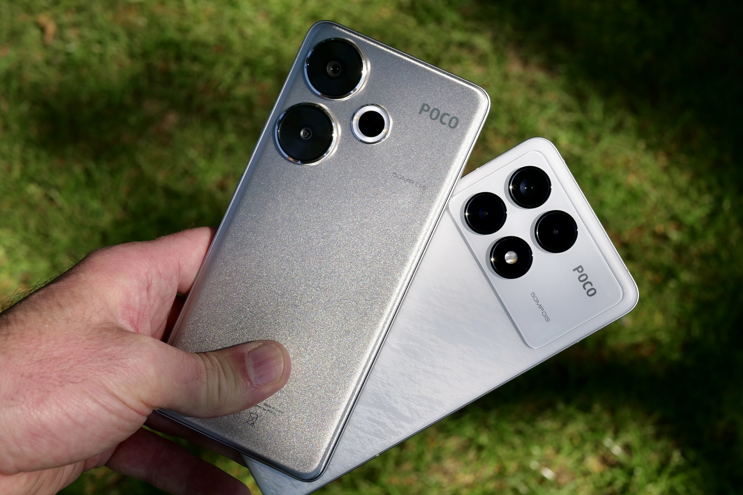 A person holding the Poco F6 and Poco F6 Pro.