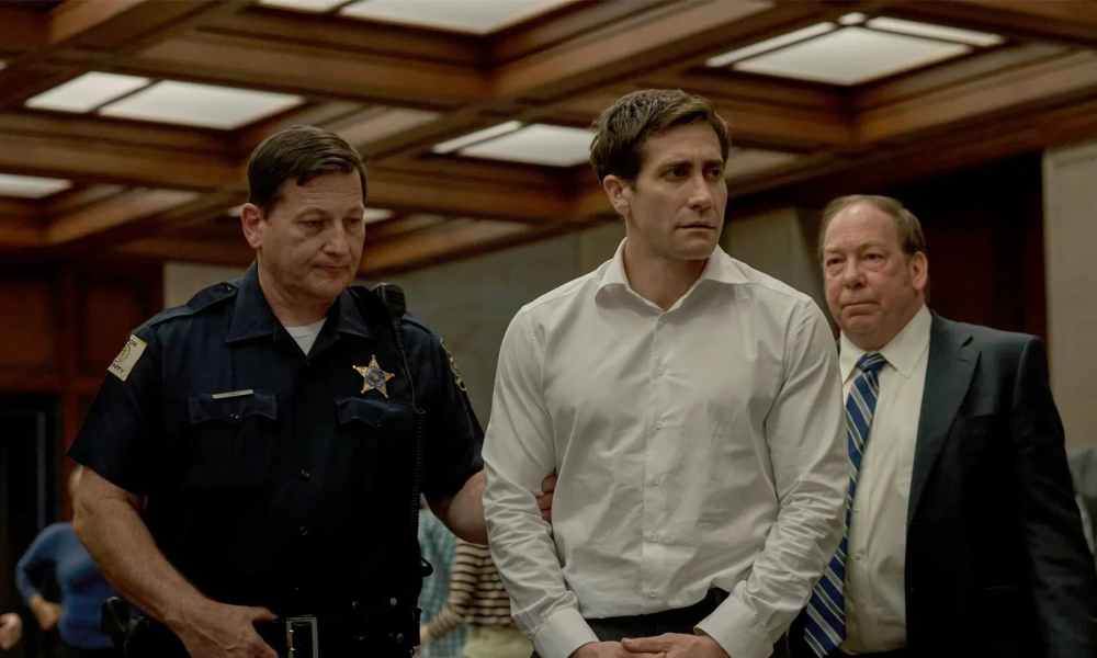 Jake Gyllenhaal being taken away in handcuffs in a scene from Presumed Innocent.