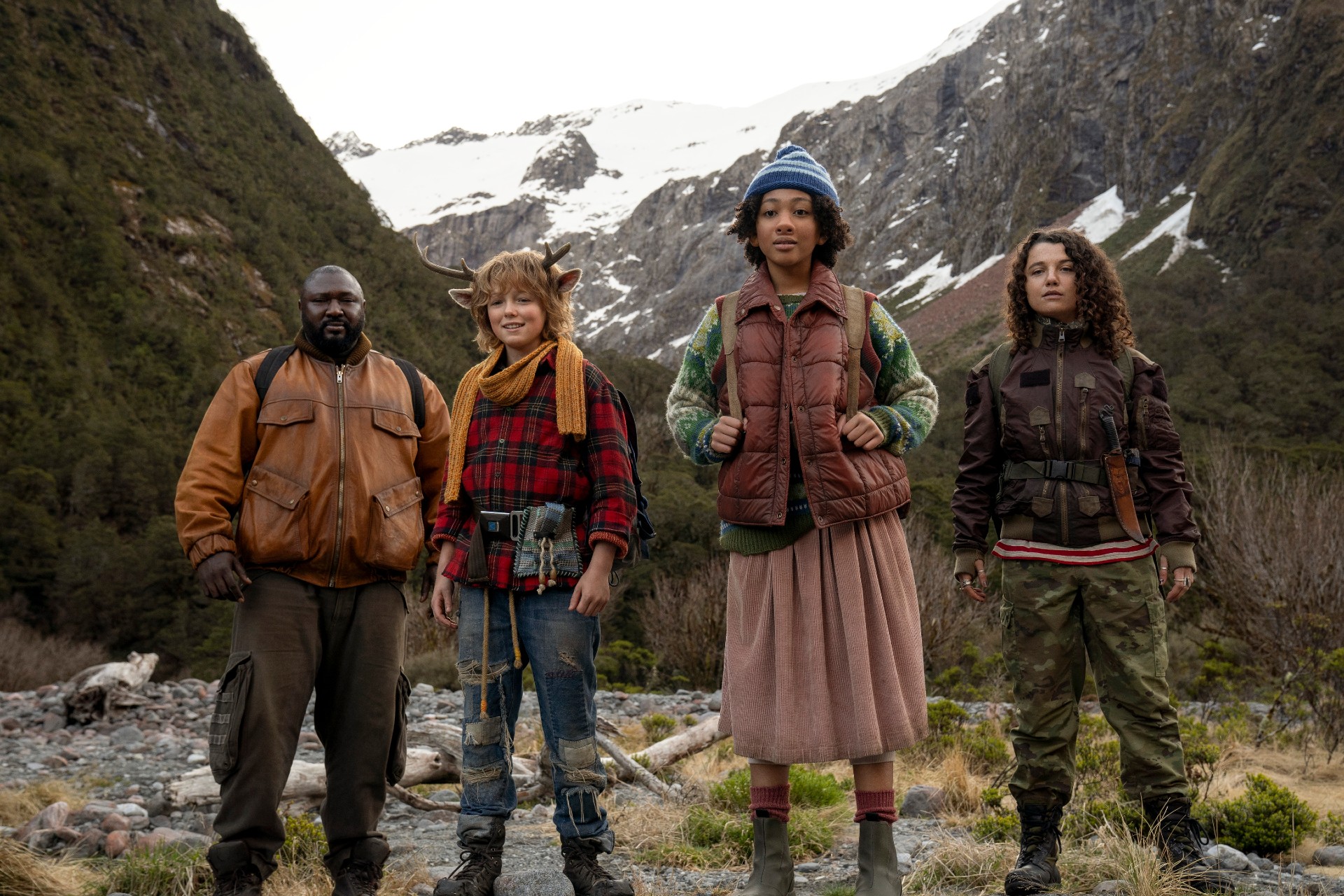 Four people stand on a mountain in Sweet Tooth.