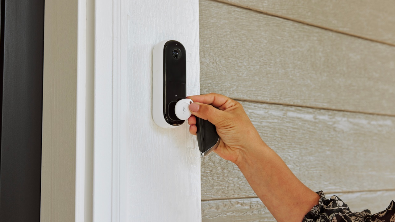 The Arlo Security Tag pressed against the Arlo Video Doorbell.