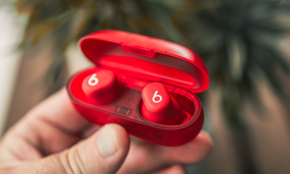 The Beats Solo Buds in their red translucent case.