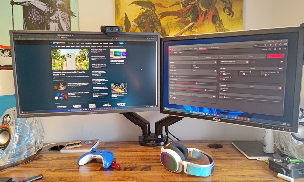 Pair of monitors on a desk with a monitor arm.